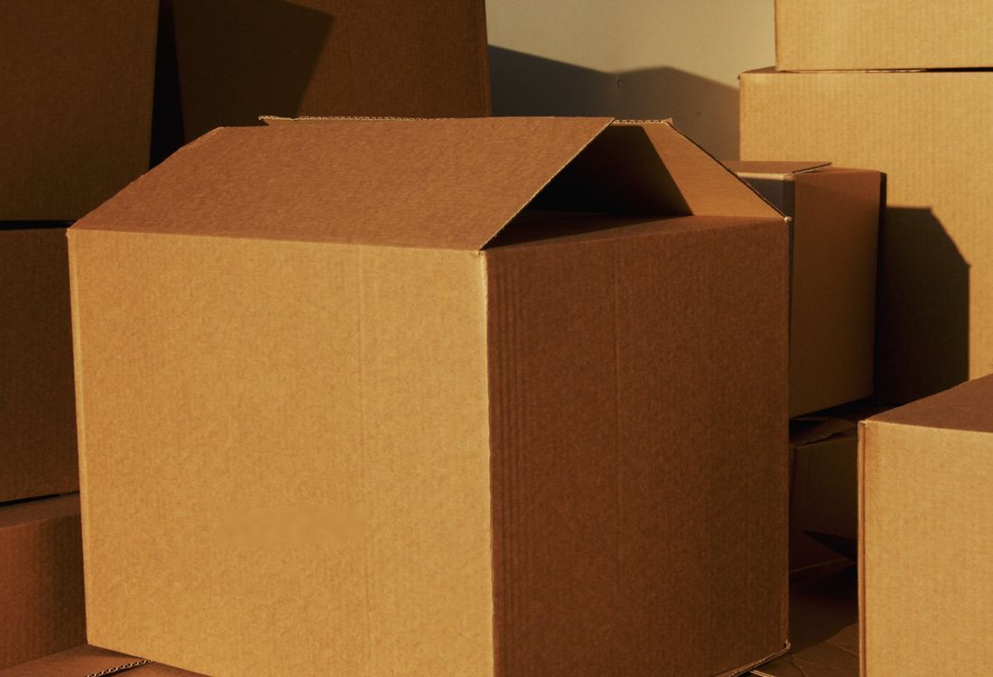 Close-up of a printed die-cut corrugated box with a product window and folded locking tabs
